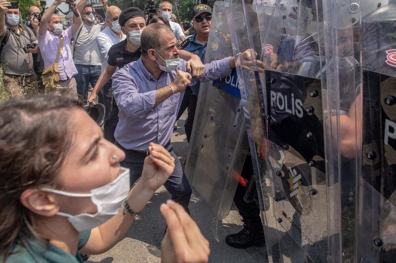 Republican People's Party (HDP) deputy Tuma Celik clash with Turkish riot police during a "March for Democracy" called by Republican People's Party (HDP), after three opposition MPs were revoked and sent to prison at Silivri, in Istanbul, on June 15, 2020.  Three opposition MPs have been detained on espionage and terrorism charges after being stripped of parliamentary immunity, in a move that critics of President Recep Tayyip Erdogan say is an attempt to neuter opposition parties before possible snap elections.  / AFP / BULENT KILIC
