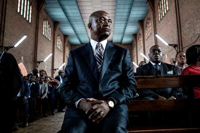(FILES) In this file photo taken on November 24, 2018 Official DRCongo Presidential candidate, Emmanuel Ramazani Shadary looks on inside the Cathedral Notre-Dame Du Congo in Kinshasa during the launch of his official electoral campaign.  The presidential elections scheduled on December 30, 2018 -- unfolding alongside legislative and municipal ballots -- have a field of 21 candidates, with three men leading the pack. They are Emmanuel Ramazani Shadary, a hardline former interior minister; Felix Tshisekedi, head of the veteran UDPS opposition; and Martin Fayulu, a little-known legislator and former oil executive. / AFP / John WESSELS
