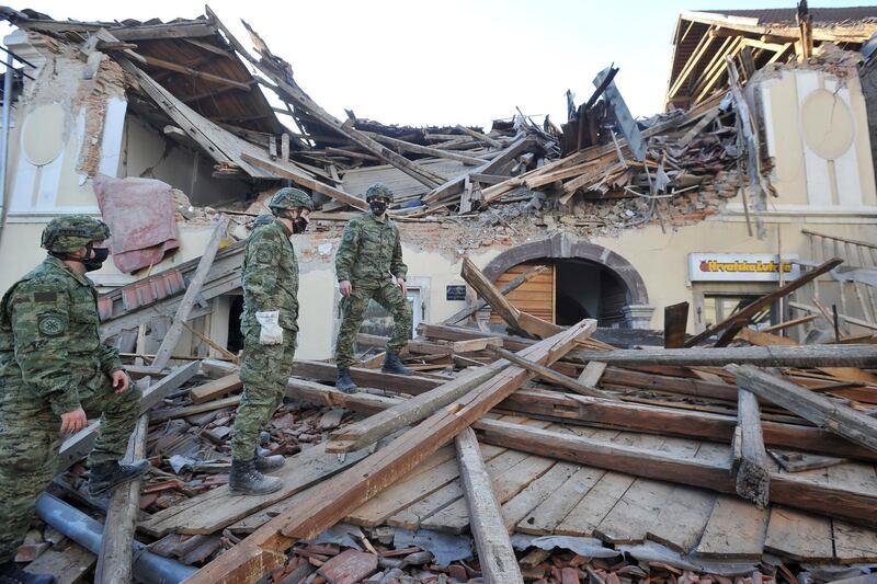 Soldiers inspect remains of a building damaged in an earthquake, in Petrinja, Croatia.  AP