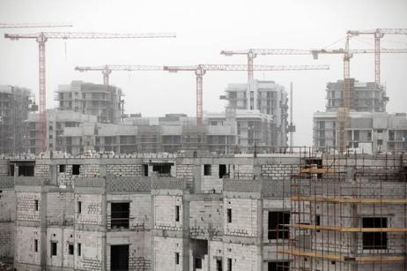 Construction at the Sorouh's Watani development in Abu Dhabi in the foreground. Sammy Dallal / The National