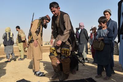 Taliban leader Abu Do Jana, centre, gets ready to compete in a buzkashi game at Qara Shabagh last October. AFP