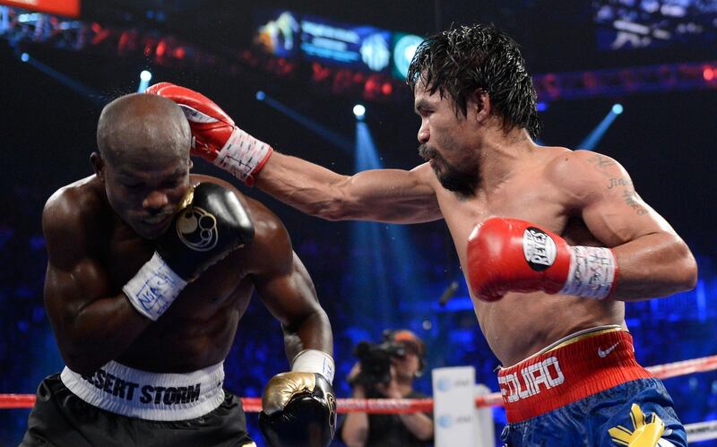 LAS VEGAS, NV - JUNE 09:  (R-L) Manny Pacquiao lands a right to the head of Timothy Bradley during their WBO welterweight title fight at MGM Grand Garden Arena on June 9, 2012 in Las Vegas, Nevada.  (Photo by Kevork Djansezian/Getty Images)