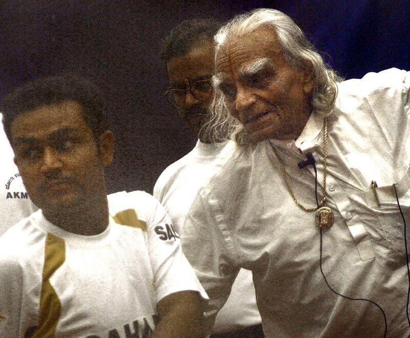 Indian yoga exponent BKS Iyenger, right, demonstrates a stretching exercise to Indian cricketer Virender Sehwag. Iyengar started his yoga school in 1973 in the western city of Pune, developing a unique form of the practice that he said anyone could follow. Indranil Mukherjee / AFP Photo