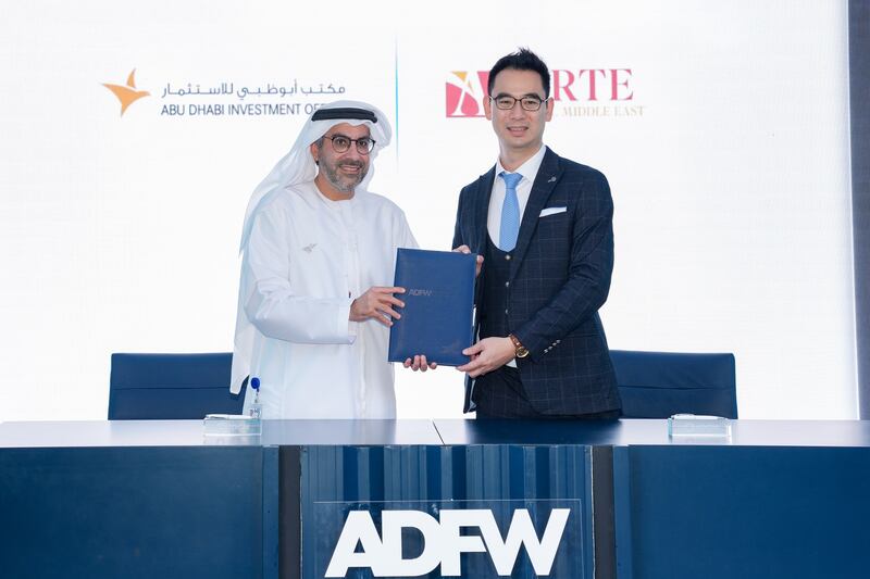 Badr Al Olama, director general of the Abu Dhabi Investment Office, and Ethan Chan, chairman of Arte Capital Group, welcome a preliminary agreement at Abu Dhabi Finance Week. Photo: Adio