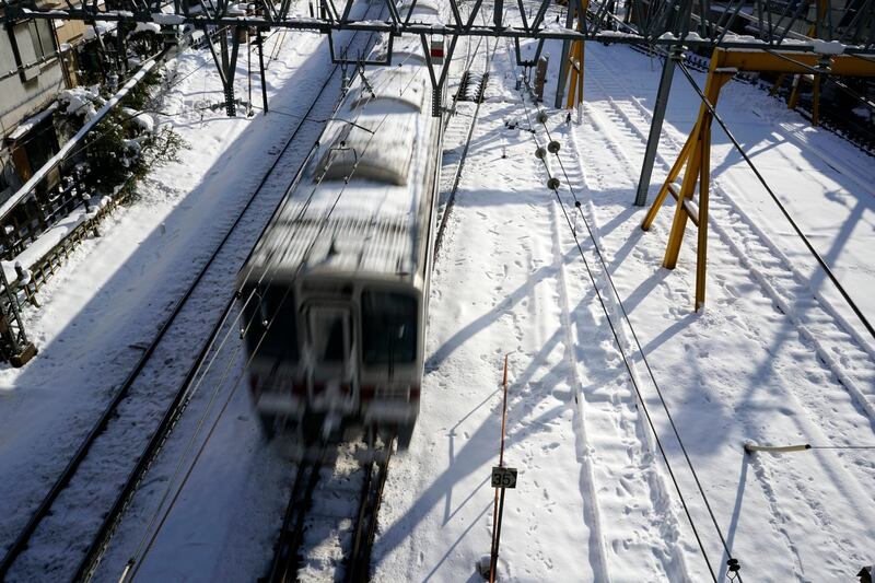 This picture, taken on January 23, 2018, shows a train on rail tracks covered with snow in Tokyo, Japan. Franck Robichon / EPA