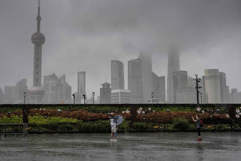 People pose for a photo along an empty Bund in Shanghai.