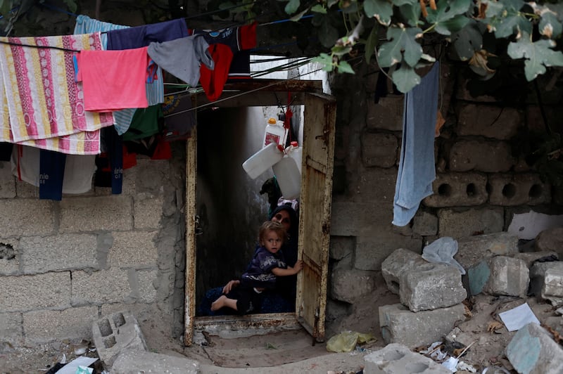 Khadija Kuhail, 30, with her son, Mohanad, 1, in the doorway of their home at the Sheikh Shaban cemetery. Gaza's population is set to more than double within the next 30 years to 4.8 million and already land is running out.
