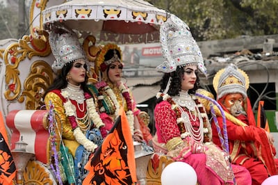 Artists dressed as Hindu deities ride a chariot. AFP