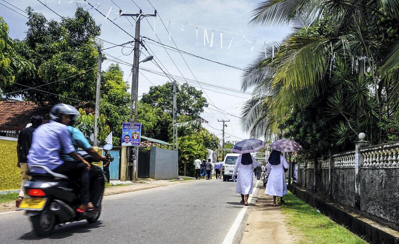 Catholic nuns walk down the street away from St Sebastian’s Church in Negombo, Sri Lanka, April 23, 2019. Jack Moore / The National
