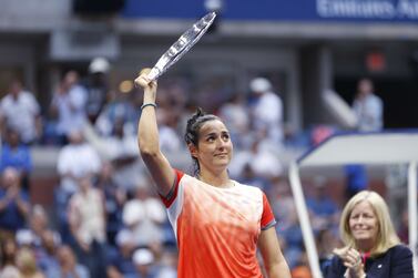 NEW YORK, NEW YORK - SEPTEMBER 10: Ons Jabeur of Tunisia celebrates with the runner-up trophy after being defeated by Iga Swiatek of Poland during their Women’s Singles Final match on Day Thirteen of the 2022 US Open at USTA Billie Jean King National Tennis Center on September 10, 2022 in the Flushing neighborhood of the Queens borough of New York City.    Sarah Stier / Getty Images / AFP