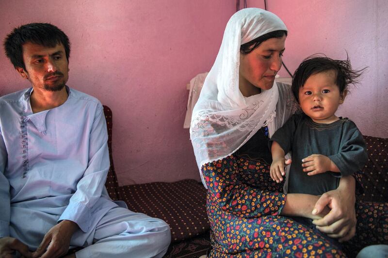 Shakira Nuddin, 30, sits in her house in Khaja Gulrang village, Badakhshan, holding her youngest son. 