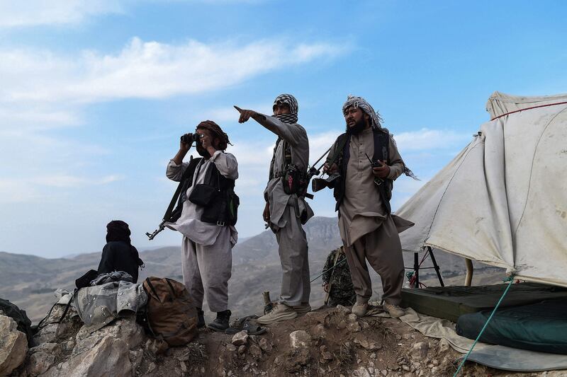 Afghan militia fighters keep watch for Taliban insurgents at an outpost in Charkint district in Balkh province. AFP