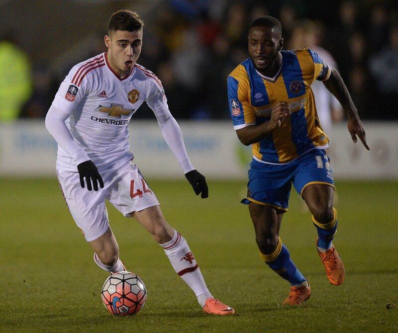 Manchester United's Belgian midfielder Andreas Pereira (L) vies with Shrewsbury Town's English defender Abu Ogogo during the English FA Cup fifth round football match between Shrewsbury Town and Manchester United at the Greenhous Meadow stadium in Shrewsbury, western England on February 22, 2016.  Manchester United won the match 3-0.  AFP PHOTO / OLI SCARFFRESTRICTED TO EDITORIAL USE. No use with unauthorized audio, video, data, fixture lists, club/league logos or 'live' services. Online in-match use limited to 75 images, no video emulation. No use in betting, games or single club/league/player publications.