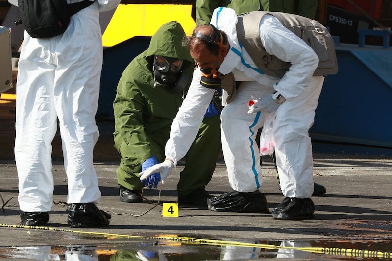 Jordanian emergency services and forensics experts inspect the site of a toxic gas explosion in the Red Sea port of Aqaba. AFP