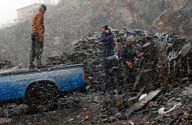 Afghan workers during a snowy day in the city of Meygun, north of Tehran, Iran.  Figures  issued by the Iranian Government in October 2020 showed about 780,000 Afghans were living in Iran as refugees. EPA