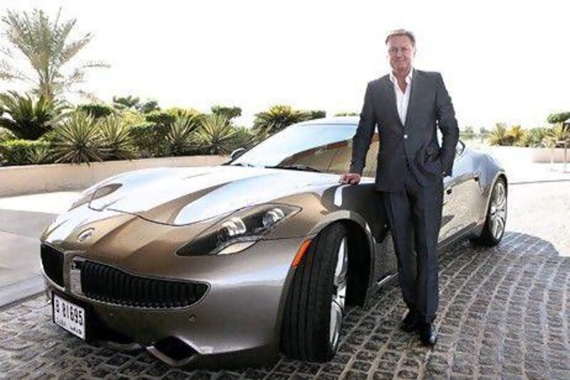 Henrik Fisker, executive chairman of Fisker Automotive, stands beside a Fisker Karma electric sports car, which he says is a perfect fit for the UAE, in Dubai yesterday. Jeffrey E Biteng / The National