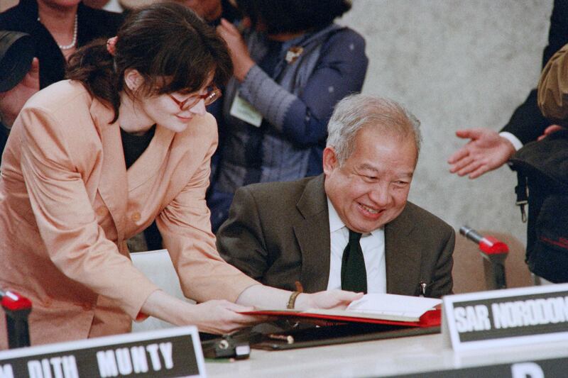 Cambodia's Prince Norodom Sihanouk signs the agreement during the Cambodia Peace Conference in Paris. AFP