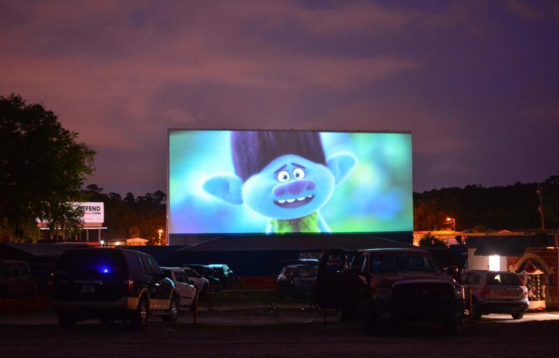 People watch the movie 'Trolls World Tour' from their cars at the Ocala drive-in theatre in Ocala, Florida. AFP