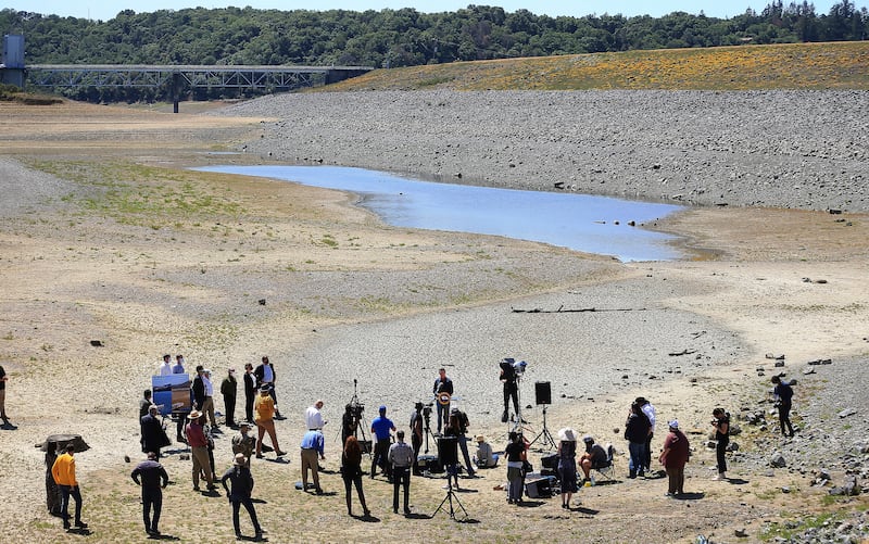 Gavin Newsom holds a conference in the parched basin of Lake Mendocino in Ukiah, California, where he announced a drought emergency for Mendocino and Sonoma counties.  Kent Porter / The Press Democrat via AP