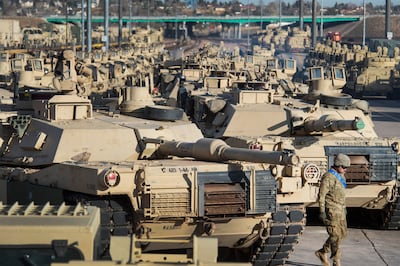 A soldier walks past a line of M1 Abrams tanks at Fort Carson in Colorado Springs, Colorado. AP