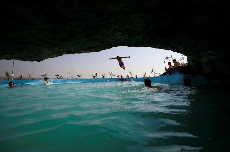 Children swim in a pool built by Palestinian man Mohammed Al Khatib  on a rocky hill amid the coronavirus outbreak in Bilin in the occupied West Bank. Reuters