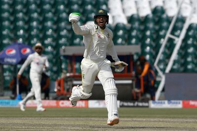 Australia's Usman Khawaja celebrates after scoring a century on the fourth day of the third Test at the Gaddafi Stadium in Lahore. AFP