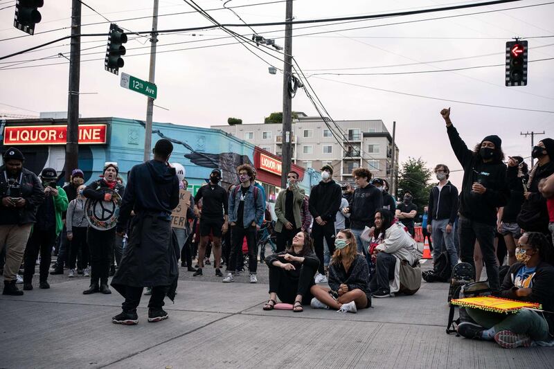 People rally in front of the Seattle Police Departments East Precinct in the so-called "Capitol Hill Autonomous Zone" in Seattle, Washington. Getty Images/AFP