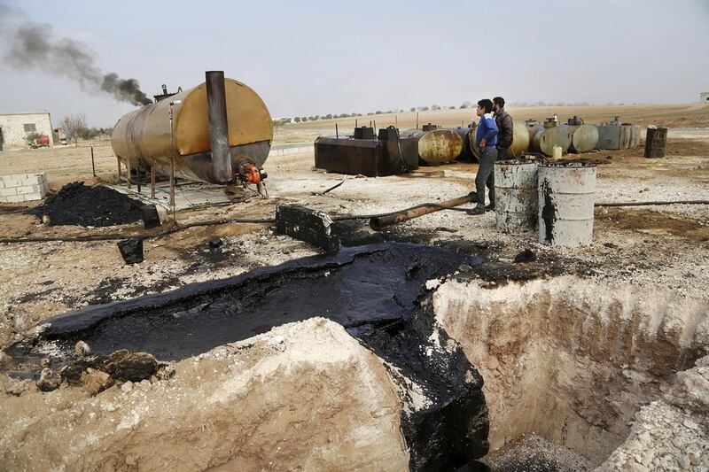 A makeshift oil refinery in Marchmarin town, Idlib, Syria. The operation’s owner gets the crude from ISIL-controlled areas in Deir Ezzour province and Iraq. Khalil Ashawi / Reuters