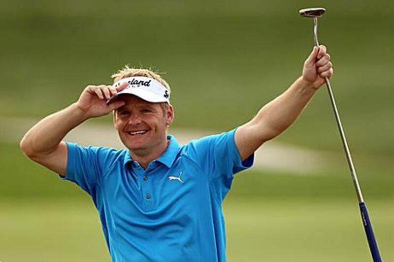 Soren Kjeldsen of Denmark celebrates after his hole in one on the par three 7th.