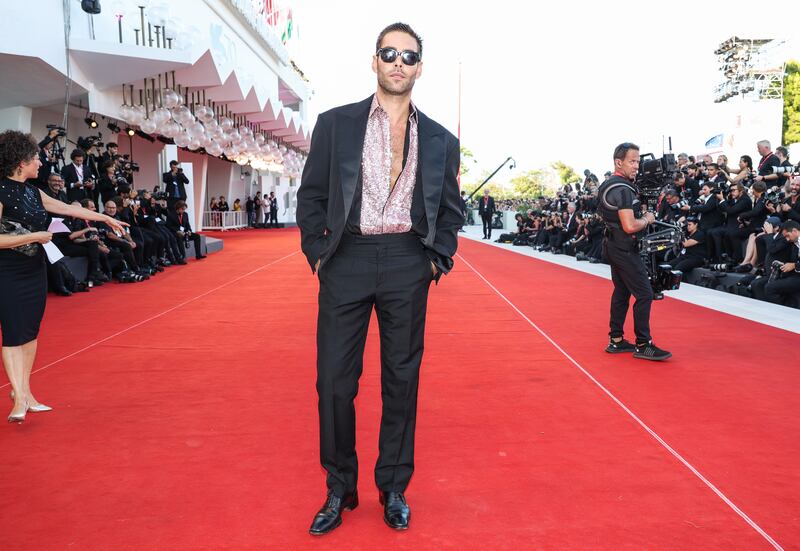 Jon Kortajarena wears a slick suit with an open satin shirt. Getty Images