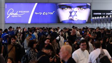 Passengers wait to check-in in the departure terminal in Ben Gurion airport on the morning after a drone and missile attack from Iran. Bloomberg