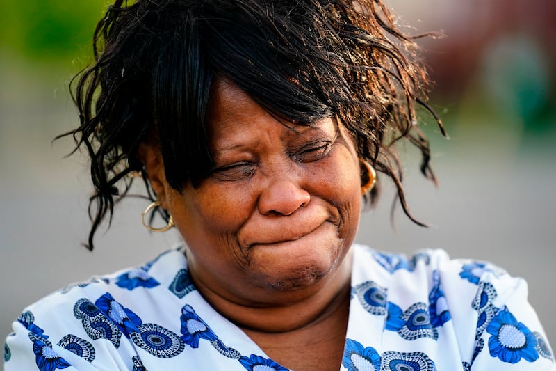 Stephanie Morris is overcome with emotion after news of the fatal shooting spread. AP