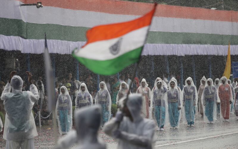 Students are undaunted by heavy rain as they parade on Independence Day in Kolkata. EPA