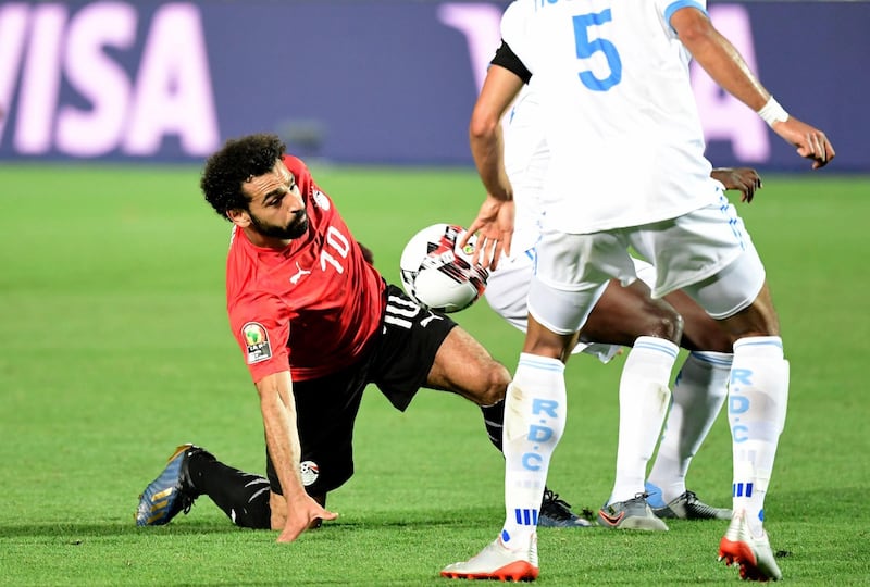 Egypt's forward Mohamed Salah loses his footing after a challenge from a DR Congo player. EPA