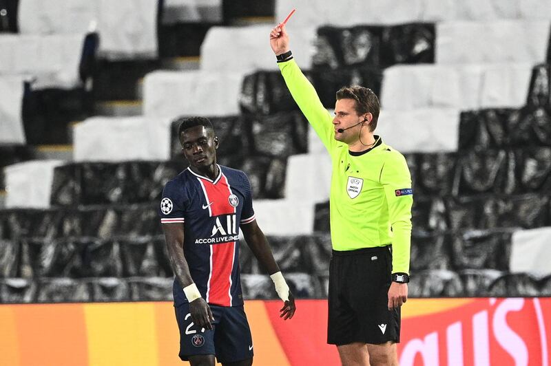 Referee Felix Brych shows a red card to Paris Saint-Germain midfielder Idrissa Gueye. AFP