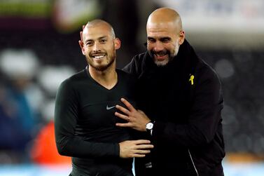 Soccer Football - Premier League - Swansea City vs Manchester City - Liberty Stadium, Swansea, Britain - December 13, 2017 Manchester City manager Pep Guardiola celebrates with David Silva at the end of the match Action Images via Reuters/Andrew Boyers EDITORIAL USE ONLY. No use with unauthorized audio, video, data, fixture lists, club/league logos or 'live' services. Online in-match use limited to 75 images, no video emulation. No use in betting, games or single club/league/player publications. Please contact your account representative for further details.