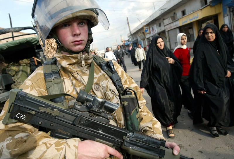 A British soldier keeps watch over a street in Al Zuber outside of the Iraqi port city of Basra in December 2003. EPA