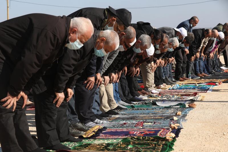 Palestinians pray during a demonstration against the expansion of settlements in the West Bank town of Salfit, near the Israeli settlement of Ariel. EPA