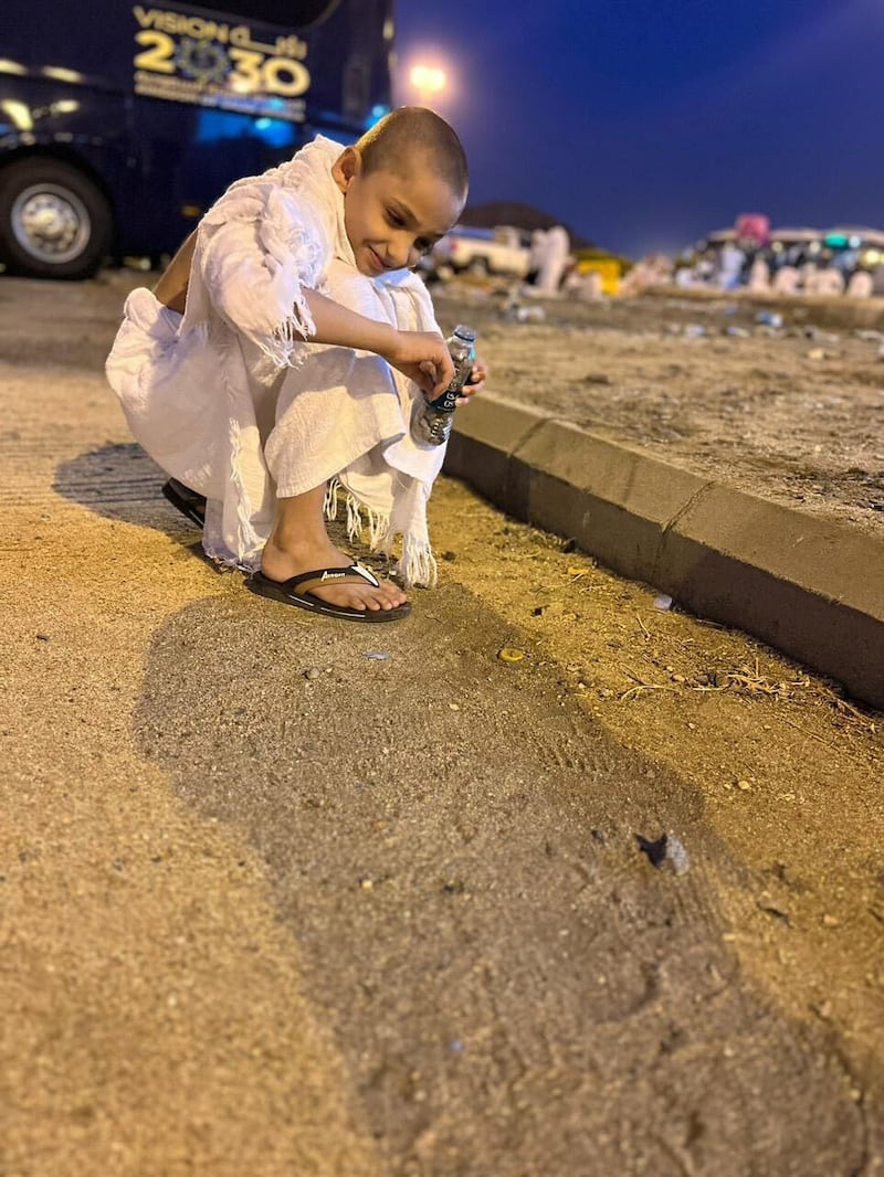 Mohammed collects pebbles ahead of the stoning of the devil ritual.