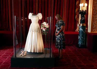 WINDSOR, ENGLAND - SEPTEMBER 23: Princess Beatrice poses alongside her wedding dress as it goes on display at Windsor Castle on September 23, 2020 in Windsor, England. Princess Beatrice and Edoardo Mapelli Mozzi married on July 18, 2020 in Windsor. (Photo by Steve Parsons - WPA Pool/Getty Images)