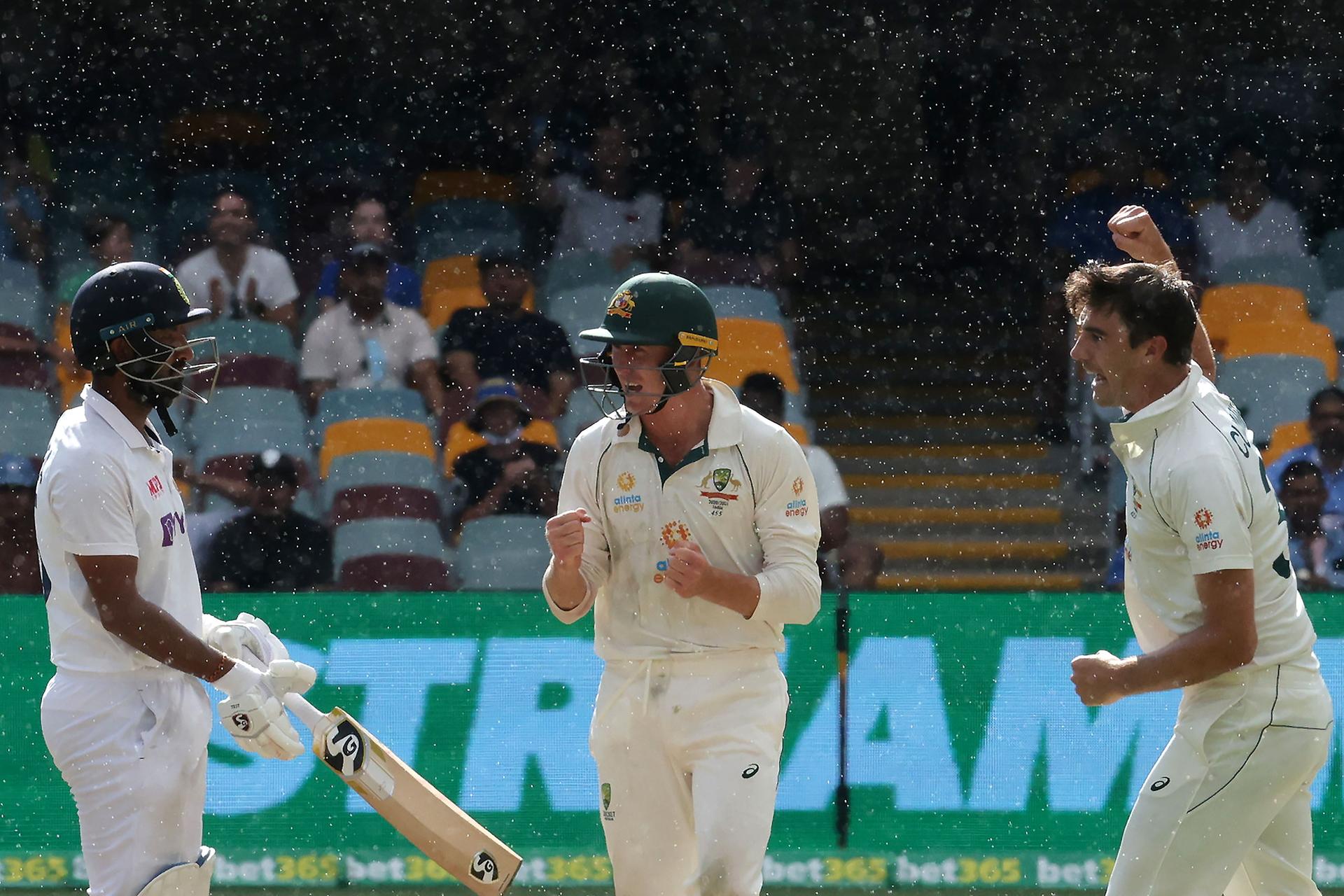 Pat Cummins and Marnus Labuschagne celebrate the wicket of Cheteshwar Pujara. AFP