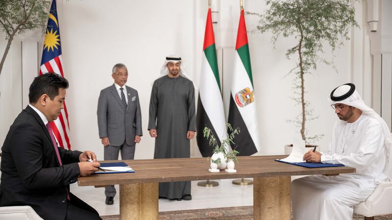 President Sheikh Mohamed and Malaysia's king, Sultan Abdullah Sultan Ahmad Shah, witness the signing of an agreement between Adnoc and Petronas by Dr Sultan Al Jaber, UAE Minister of Industry and Advanced Technology and group chief executive of Adnoc, and Datuk Tengku Muhammad Taufik, president and group chief executive of Petronas. All photos: UAE Presidential Court