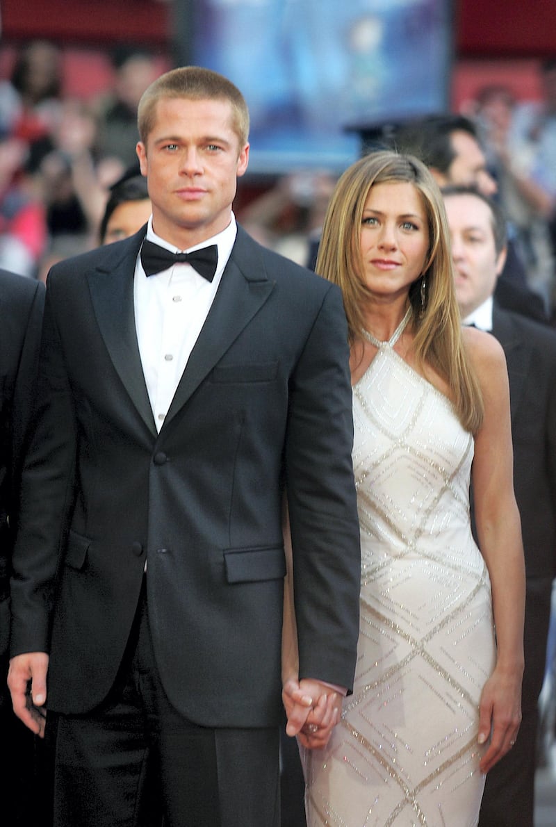 US actor Brad Pitt and his wife Jennifer Aniston arrive to attend the screening of US director Wolfgang Petersen's film "Troy", 13 May 2004, at the 57th Cannes Film Festival in the French Riviera town. Hollywood took over the French Riviera today as Brad Pitt and his co-stars of the epic movie arrived to present their 175 million dollar (147 million euro)-plus swords-and-sandals feature, being shown out of competition, in the blaze of Cannes publicity.  AFP PHOTO/BORIS HORVAT (Photo by BORIS HORVAT / AFP)