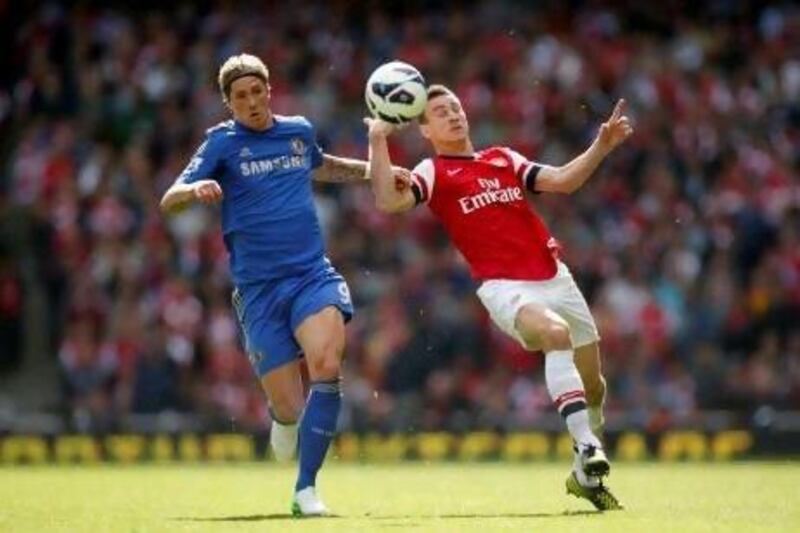 Arsenal's Laurent Koscielny, right, competes for the ball with Chelsea's Fernando Torres.
