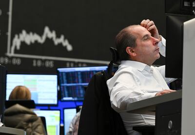 Stock trader Arthur Brunner of ICF Bank watches his monitor on the floor of the Frankfurt Stock Exchange.  The Russian attack on Ukraine has sent stock markets worldwide on a downward slide. AP