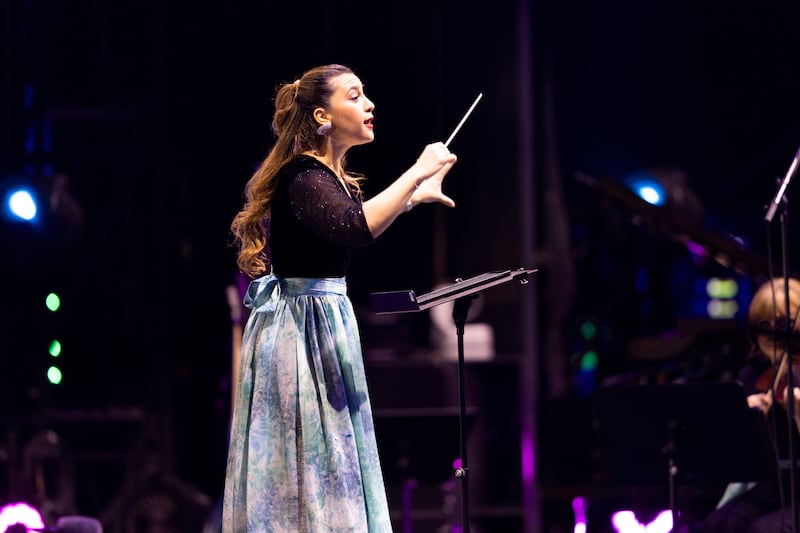 Conductor Yasmina Sabbah leads the orchestra.