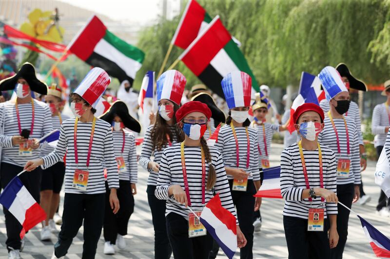 People parade on French national day at Expo 2020, Dubai. Chris Whiteoak / The National