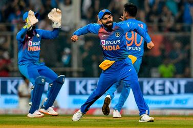 India's captain Virat Kohli (C) celebrates with teammates after the wicket of West Indies' Nicholas Pooran during the third T20 international cricket match of a three-match series between India and West Indies at the Wankhede Stadium in Mumbai on December 11, 2019. - ----IMAGE RESTRICTED TO EDITORIAL USE - STRICTLY NO COMMERCIAL USE----- / AFP / PUNIT PARANJPE / ----IMAGE RESTRICTED TO EDITORIAL USE - STRICTLY NO COMMERCIAL USE-----