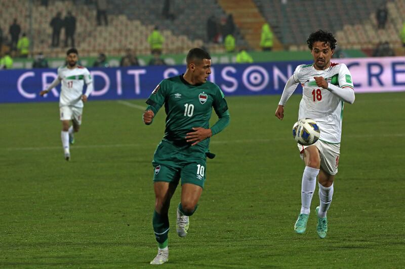 Iran's Omid Nor Afkan, right, and Iraq's Ali Ibrahim Alzubaidi vie for the ball during their 2022 World Cup qualifier at the Azadi Stadium in Tehran.  Iran became the first team from Asia to qualify for this year's World Cup. AP