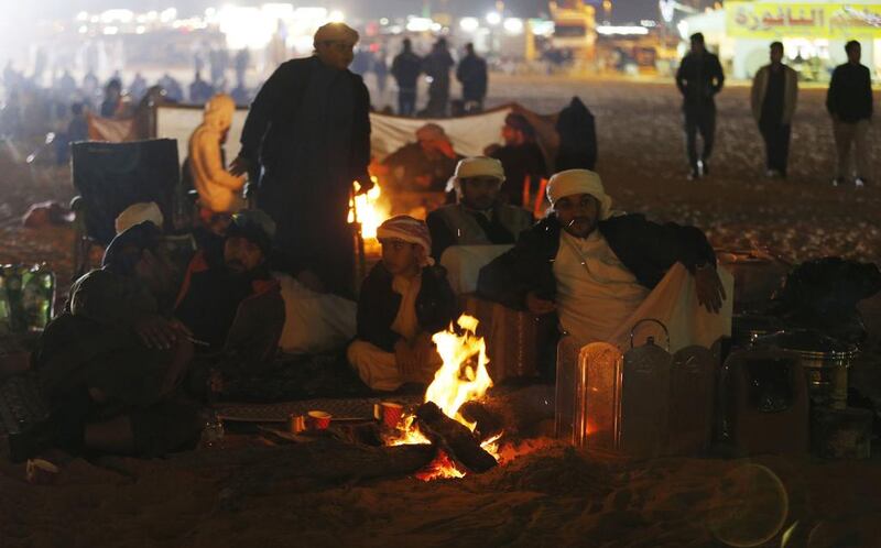 Emiratis attend a sand dune drag racing event. Karim Sahinb / AFP Photo